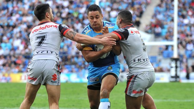 Back in the NRL: Jarryd Hayne takes on the defence in his first run for the Titans during the round 22 NRL match between the Gold Coast and the New Zealand Warriors at Cbus Super Stadium.