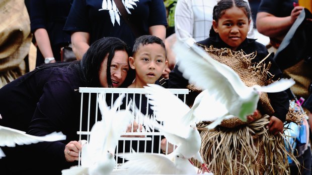 Jonah Lomu's son Brayley watches as doves are released during the public memorial at Eden Park on Monday.