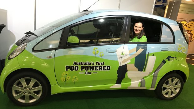 Queensland Urban Utilities spokeswoman Michelle Cull with the Poo Car at the Brisbane Ekka.