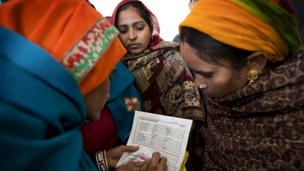 Women fill out a consent form for sterilisation surgery at a government hospital in Mahendragarh, India, earlier this month.