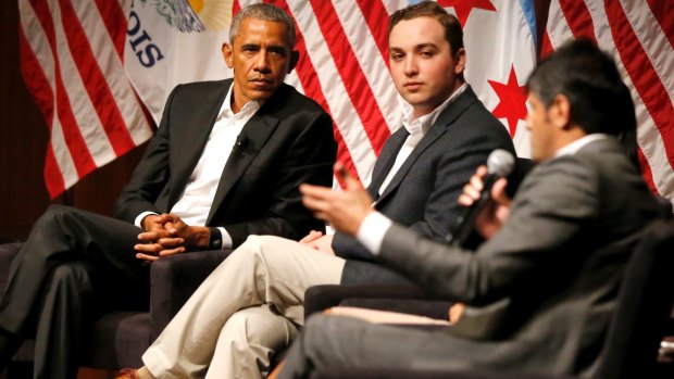 Former President Barack Obama and Max Freedman, centre, listen to Harish Patel at a civic engagement forum on Monday.