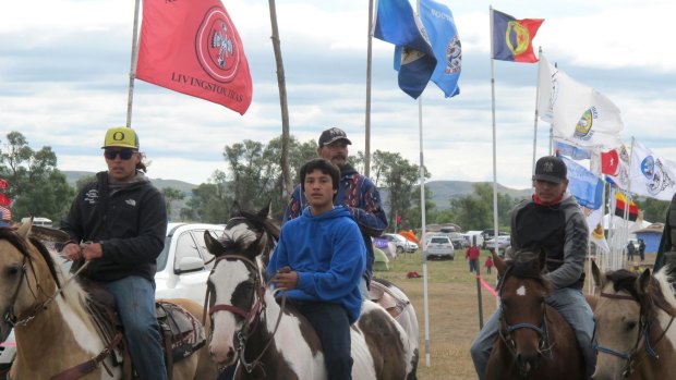 Horseback riders make their way through an encampment near North Dakota's Standing Rock Sioux reservation.