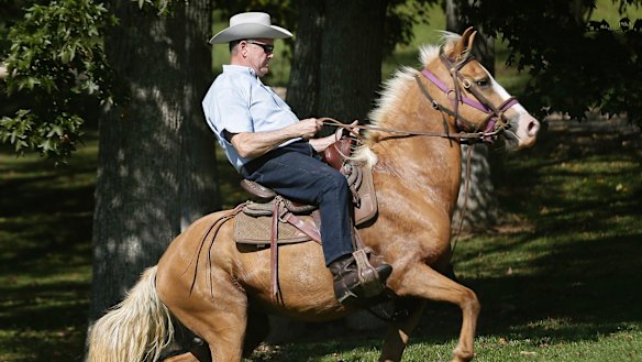 Former Alabama Chief Justice and US Senate candidate Roy Moore rides in on a horse to vote at an event during the Alabama Senate race in September. 