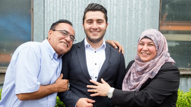 Hicham Jansis with his parents at the first-in-course ceremony. 