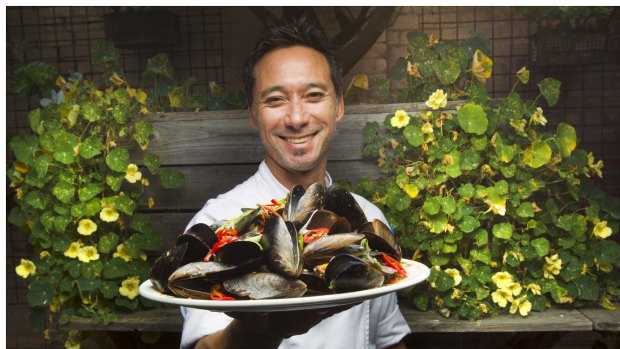 Little Creatures Geelong head chef Stephen Shing holds a plate of mussels served at the brewery restaurant.