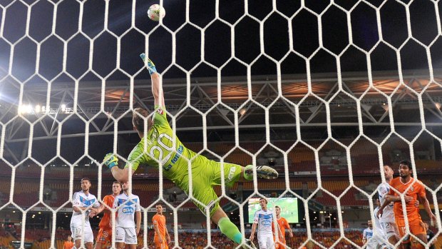 Agile: Melbourne Victory’s Lawrence Thomas makes a save during the match against Brisbane Roar. 