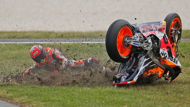 Down and dirty: Spanish world champion Marc Marquez crashes on the 10th lap.