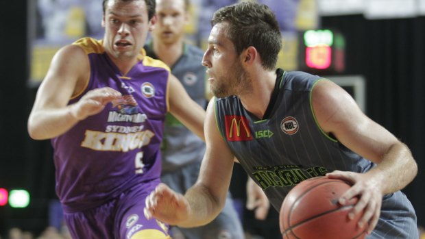 Tight affair: Townsville's Nicholas Kay on the attack with Kings guard Jason Cadee in pursuit.