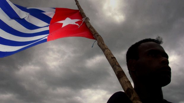 A Papaun holds the Morning Star indpendence flag.