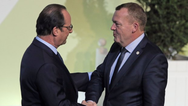 French President Francois Hollande, left, greets Danish Prime Minister Lars Lokke Rasmussen at the United Nations Climate Change Conference, in Le Bourget, outside Paris, on Monday.