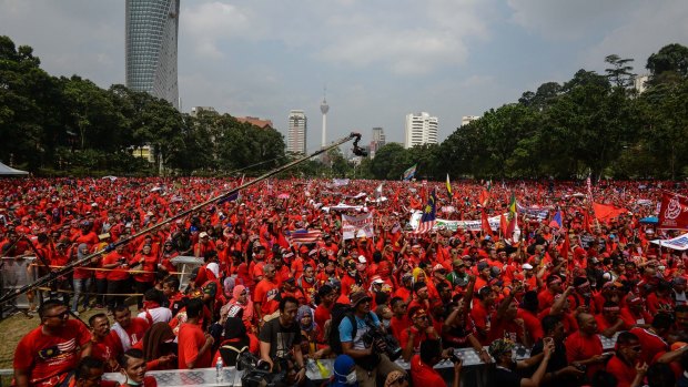 Pro-government demonstrators listen to a speech during the Kuala Lumpur rally.