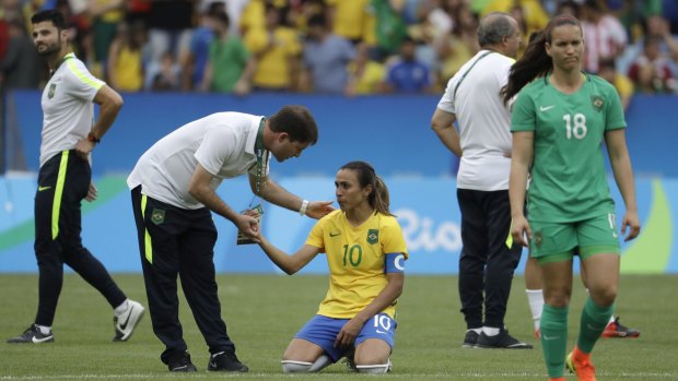 Brazilian star Marta fell to her knees and cried after the team's heartbreaking semi-final loss to Sweden at the Maracana
