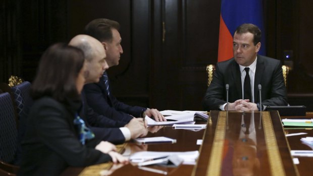 Russian Prime Minister Dmitry Medvedev (right) chairs a meeting with top central bankers near Moscow.