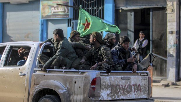 Fighters of the Kurdish People's Protection Units in the Syrian Kurdish city of Qamishli.