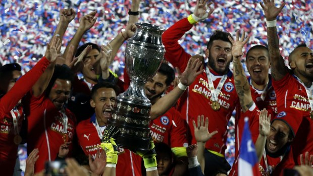 Chile's players hold up the Copa America trophy.