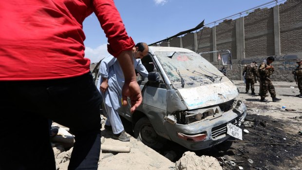 Inspecting damage after the car bomb attack in Kabul on Sunday.