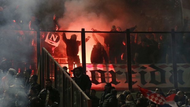 Croatia supporters light  flares on the stands.