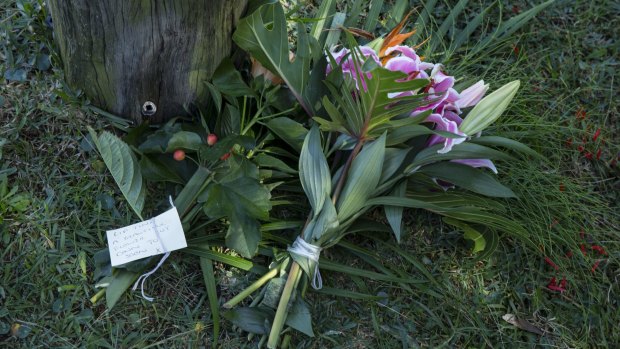 Flowers left near the house where Tina Kontozis was allegedly bashed to death.