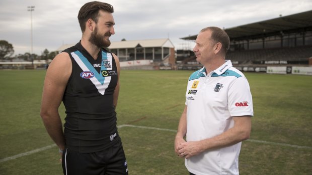 Charlie Dixon with Port Adelaide coach Ken Hinkley at Alberton Oval last year.