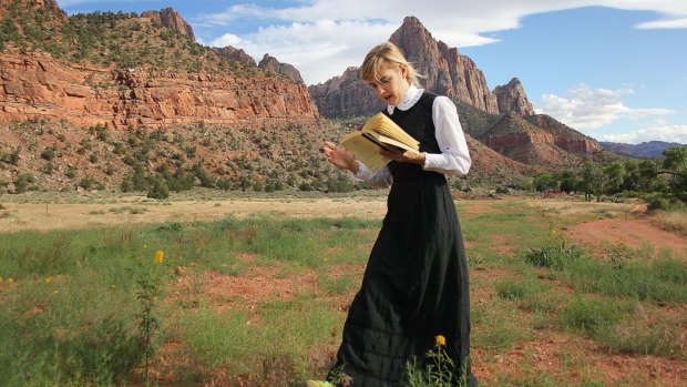 Sophia Hewson reads to mountains called the Court of the Patriarchs in Utah as research for her exhibition. 