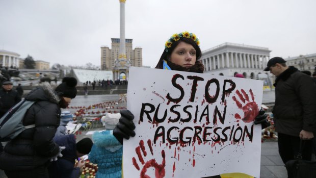 A woman holds a placard during a rally on Independence Square in Kiev on Sunday.