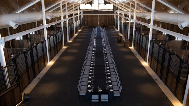 The barn set with a large dining table at the new Inglis Riverside Stables and hotel.