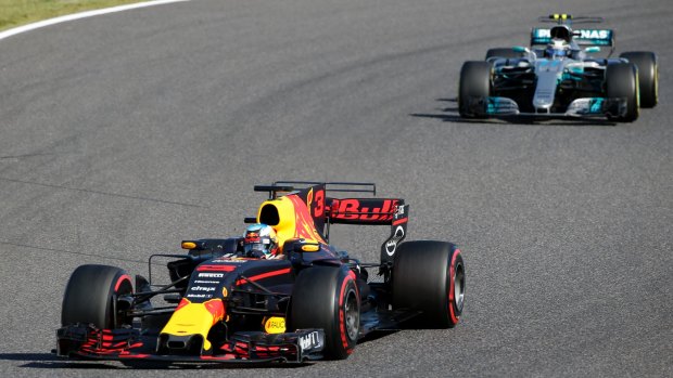 Fast break: Daniel Ricciardo of Australia leads Mercedes' Valtteri Bottas of Finland during the Japanese Formula One Grand.