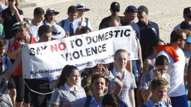 Thousands pack Coogee Beach as part of a walk in support of White Ribbon Day.  