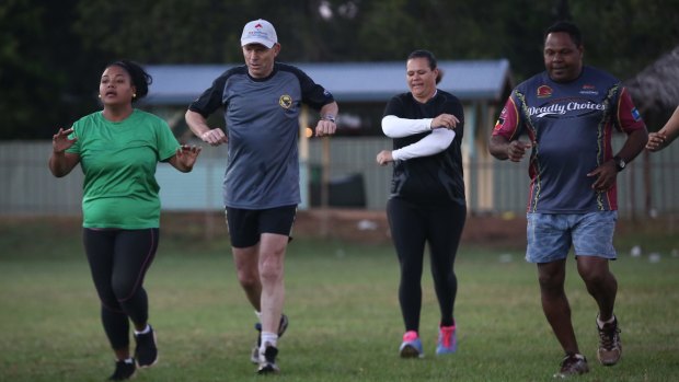 Tony Abbott works out with members of the Bamaga community during his visit to Cape York.