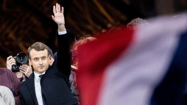 Emmanuel Macron, French presidential candidate, waves to supporters in front of the Pyramid at the Louvre Museum in Paris.