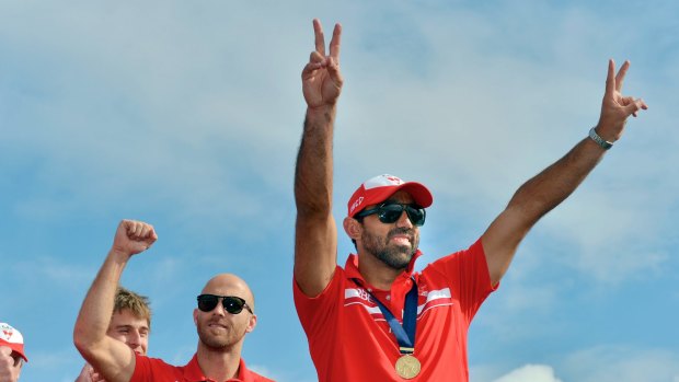 Goodes and Jarrad McVeigh with fans after winning the 2012 premiership flag.