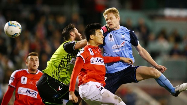 Simon says: Matthew Simon heads Sydney FC's first against Wollongong Wolves.
