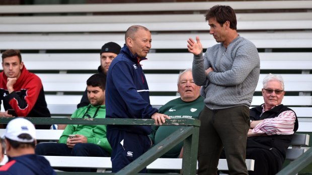 Talking tactics: England coach Eddie Jones chats with Andrew Johns at Randwick Oval during training on Monday. 