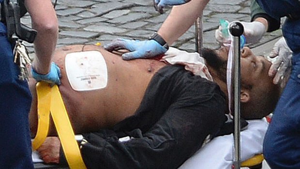 A man police have identified as Khalid Masood is treated by emergency services outside parliament.