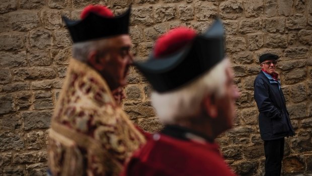 Priests wearing traditional dress take part in the Saint Saturnino procession in Pamplona, northern Spain, last month.