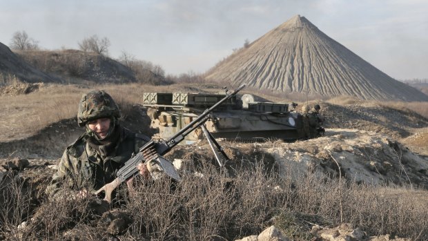 A Ukrainian serviceman takes position at the front line outside Kurahovo in Ukraine in March. 