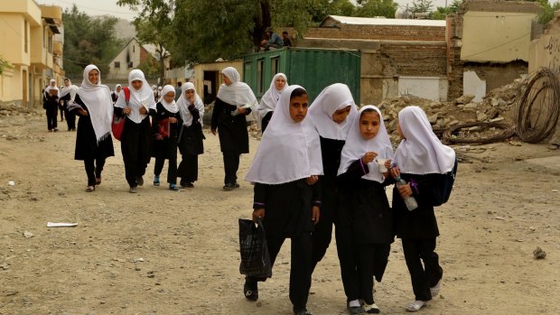 Schoolgirls walk home after class through the streets of Kabul.