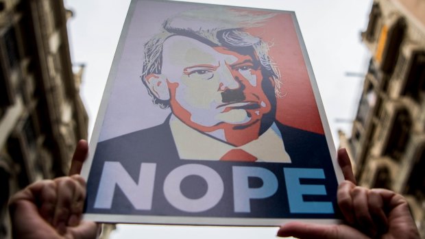 Demonstrators make their way through the streets holding posters during the Women's March in Barcelona.