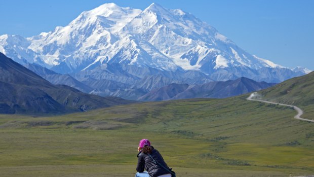 A woman gazes at North America's tallest mountain, soon to be renamed Denali.