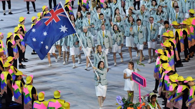 Anna Meares carries the flag for Australia at the Opening Ceremony.