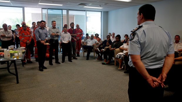 Police and emergency services personnel meet on Monday in the aftermath of the killing of eight children in Cairns.