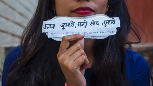 A student holds a sanitary pad with feminist messages during the viral campaign #PadsAgainstSexism by students of Jamia Millia Islamia university in Delhi in March.