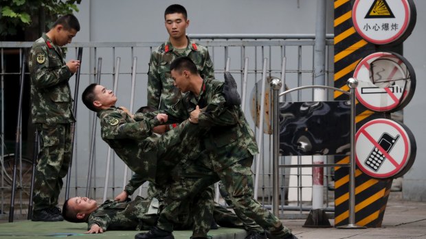 Chinese paramilitary policemen practise self-defence in Beijing. China is warning India not to underestimate its determination to safeguard what it considers sovereign territory.