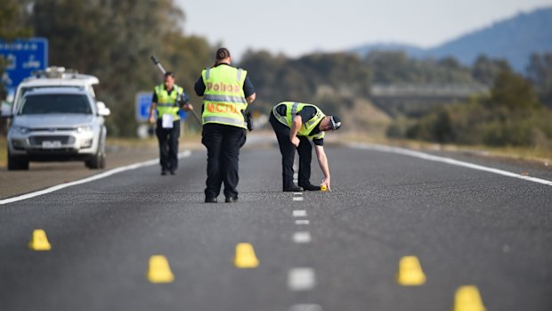 MCIU Police mark the road where the vehicles left the freeway.