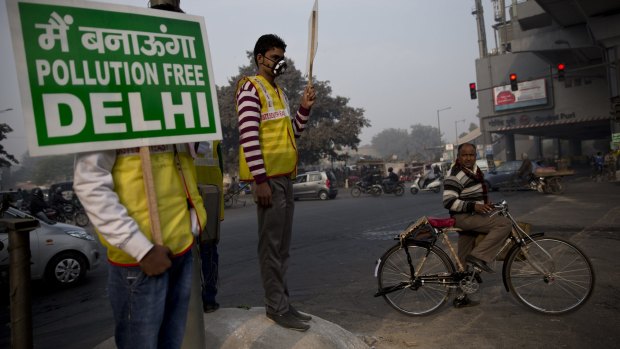 Volunteers display placards which read: "We will make a pollution free Delhi" during a two-week experiment to reduce the number of cars to fight pollution in New Delhi, India, in January. 