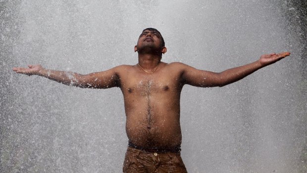 A man cools himself off at a municipal corporation water treatment plant in Agartala, India.