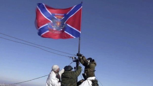 In this image from Russian Television Channel 1, separatists hoist their "New Russia" flag over  Debaltseve in eastern Ukraine on Wednesday.