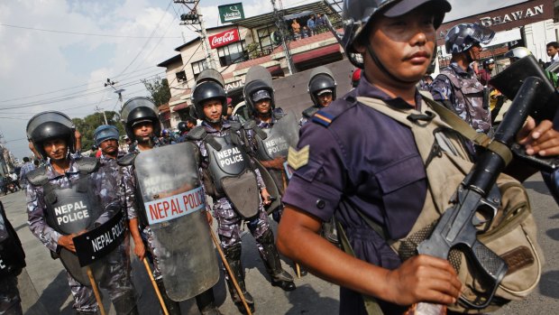 Nepalese policemen guard as students protest near the Indian Embassy in Kathmandu, Nepal on Monday.