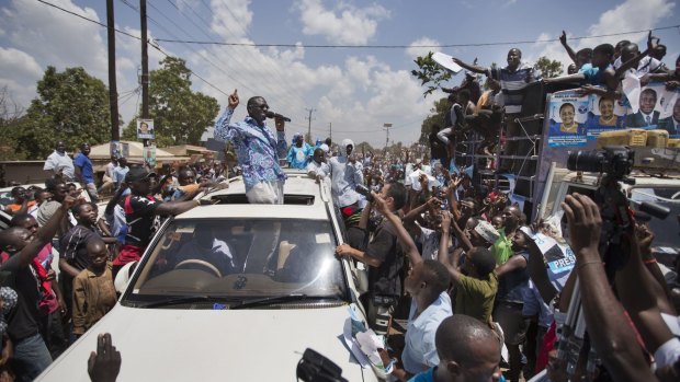 Opposition leader Kizza Besigye addresses crowds of cheering supporters outside Kampala on Tuesday. 