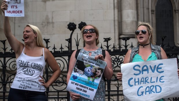 Demosntrators support Charlie Gard's parents outside the High Court in London on Monday. 
